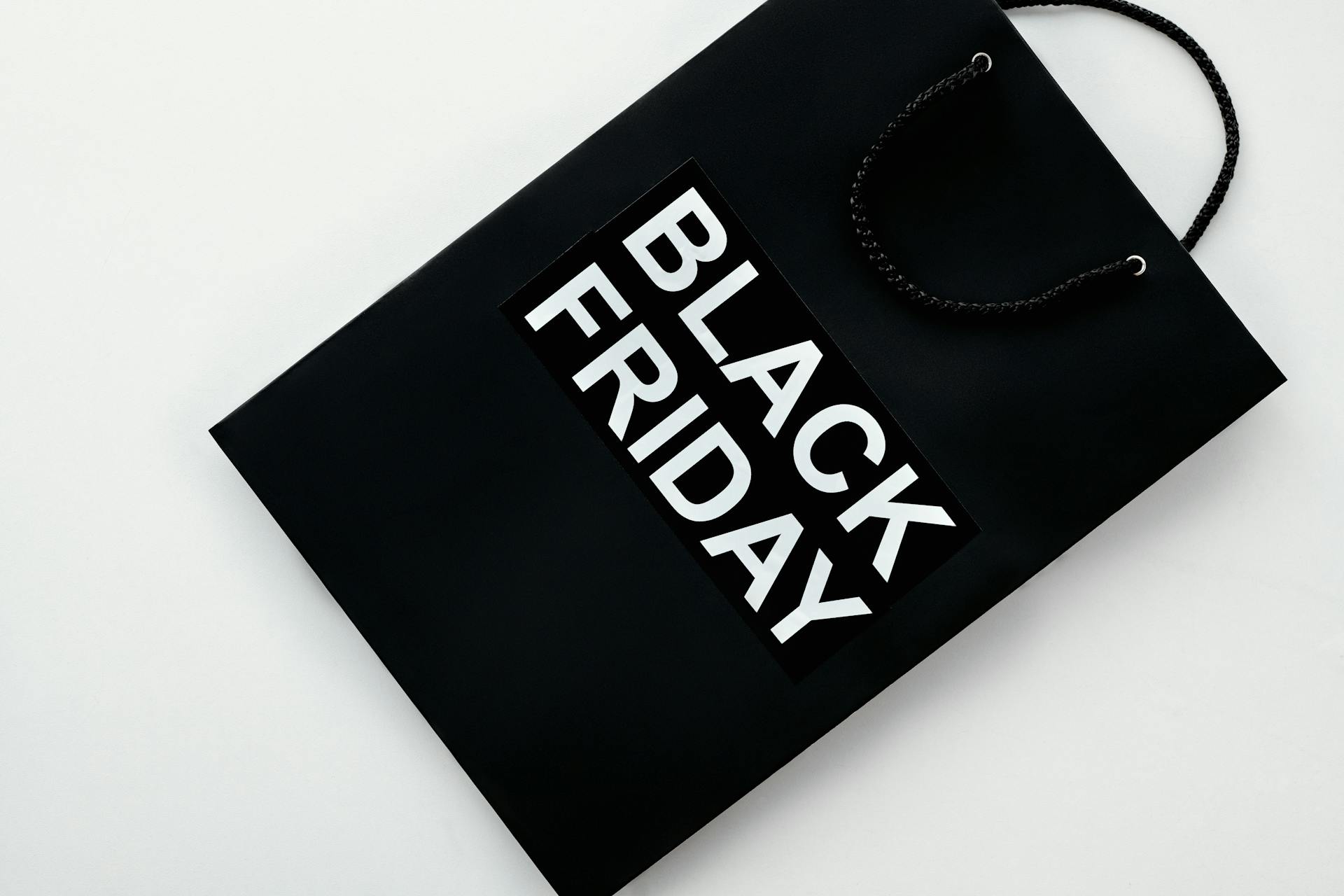 Black Friday shopping bag on a plain background for retail sales and discounts advertising.