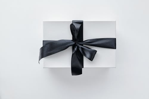 Close-Up Shot of a Gift Box Wrapped with Black Ribbon