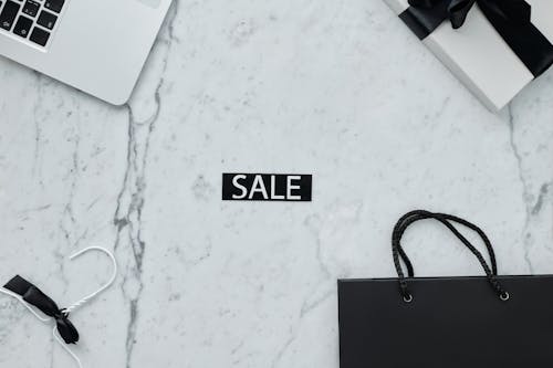 Free Close-Up Shot of a Discount Tag on a Marble Surface Stock Photo