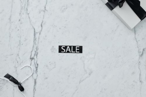 Free Elegant marble flat lay with sale tag and gift, perfect for retail promotions. Stock Photo