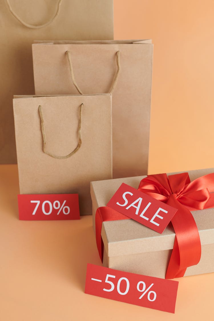 Brown Paper Bags And Cardboard Box With Sale Sign