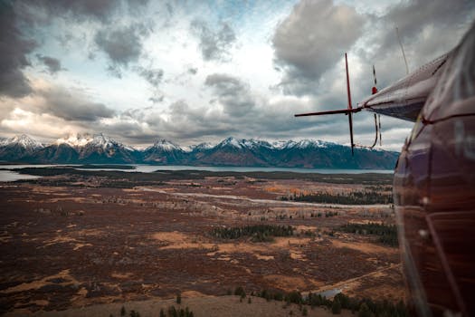 A stunning aerial view of Wyoming mountains captured from a helicopter in winter, showcasing a breathtaking landscape.