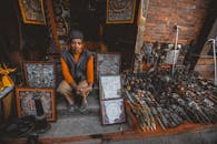 Senior Asian man seller in street oriental souvenir shop