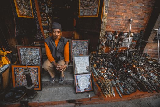 Senior Asian man seller in street oriental souvenir shop