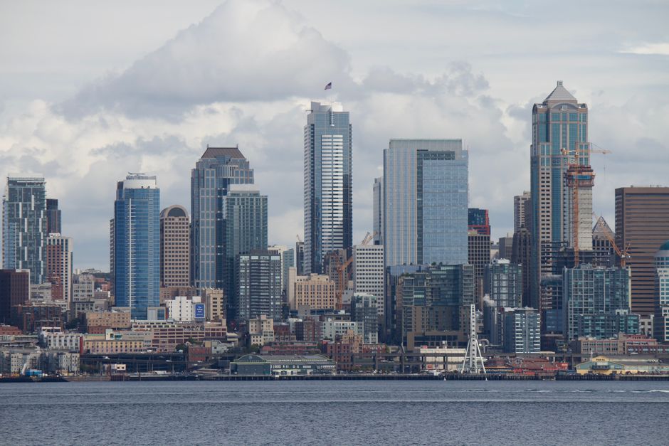 A stunning view of the Seattle skyline with skyscrapers and the iconic Space Needle across the waterfront.