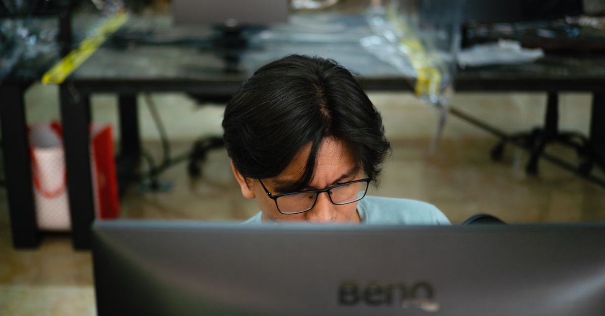 A Man Using a Computer · Free Stock Photo