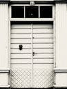 Grayscale Photo of a Wooden Door