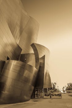 Dramatic sepia-toned image of the iconic Walt Disney Concert Hall in Los Angeles.