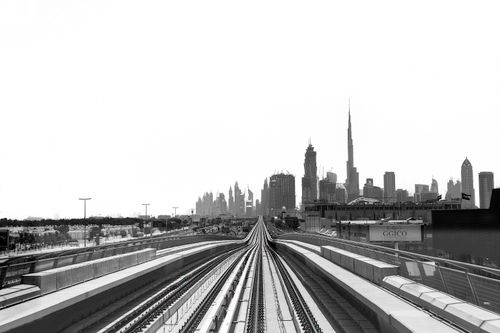 Free Black and white urban skyline with railway leading to the city, capturing modern architecture. Stock Photo