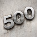 Close-Up Shot of a Metallic Signage on a Concrete Wall