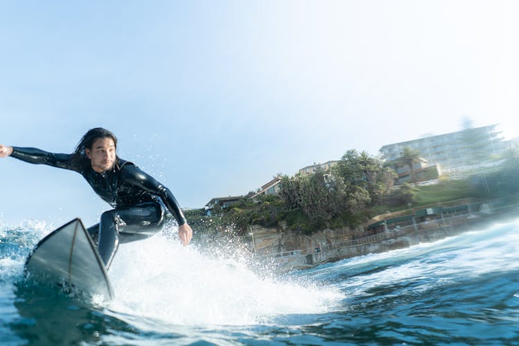 A Man Surfing On The Beach