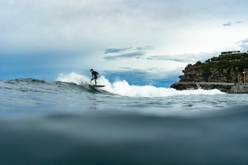 Person Surfing on Sea Waves