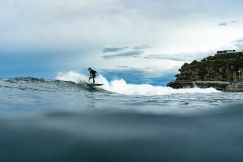Free Dynamic surfing scene with a surfer on Bronte Beach, capturing the essence of ocean adventure. Stock Photo