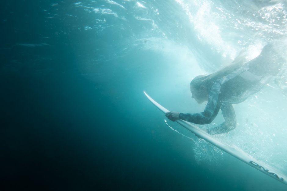 Dynamic underwater shot of a woman surfing at Bronte Beach, Australia.