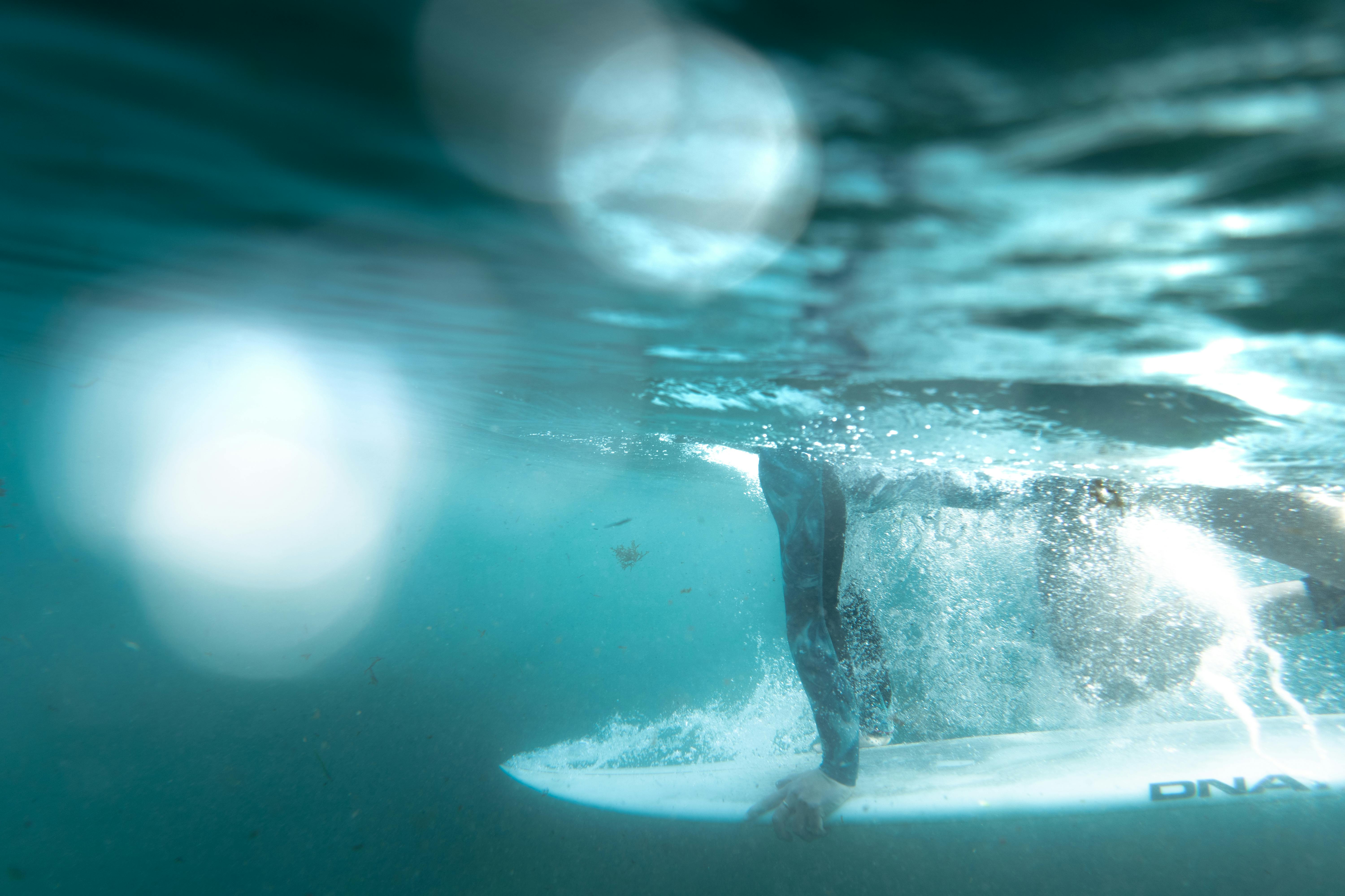 Dynamic underwater shot of a surfer riding waves at Bronte Beach, NSW, Australia.