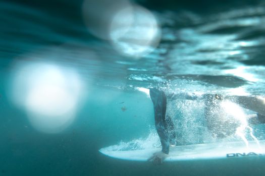 Dynamic underwater shot of a surfer riding waves at Bronte Beach, NSW, Australia.