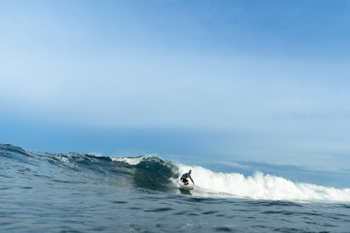Free A Person Surfing on the Sea Stock Photo