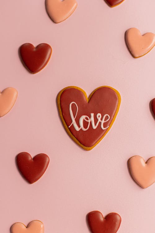 Small hearts with love word placed on surface · Free Stock Photo