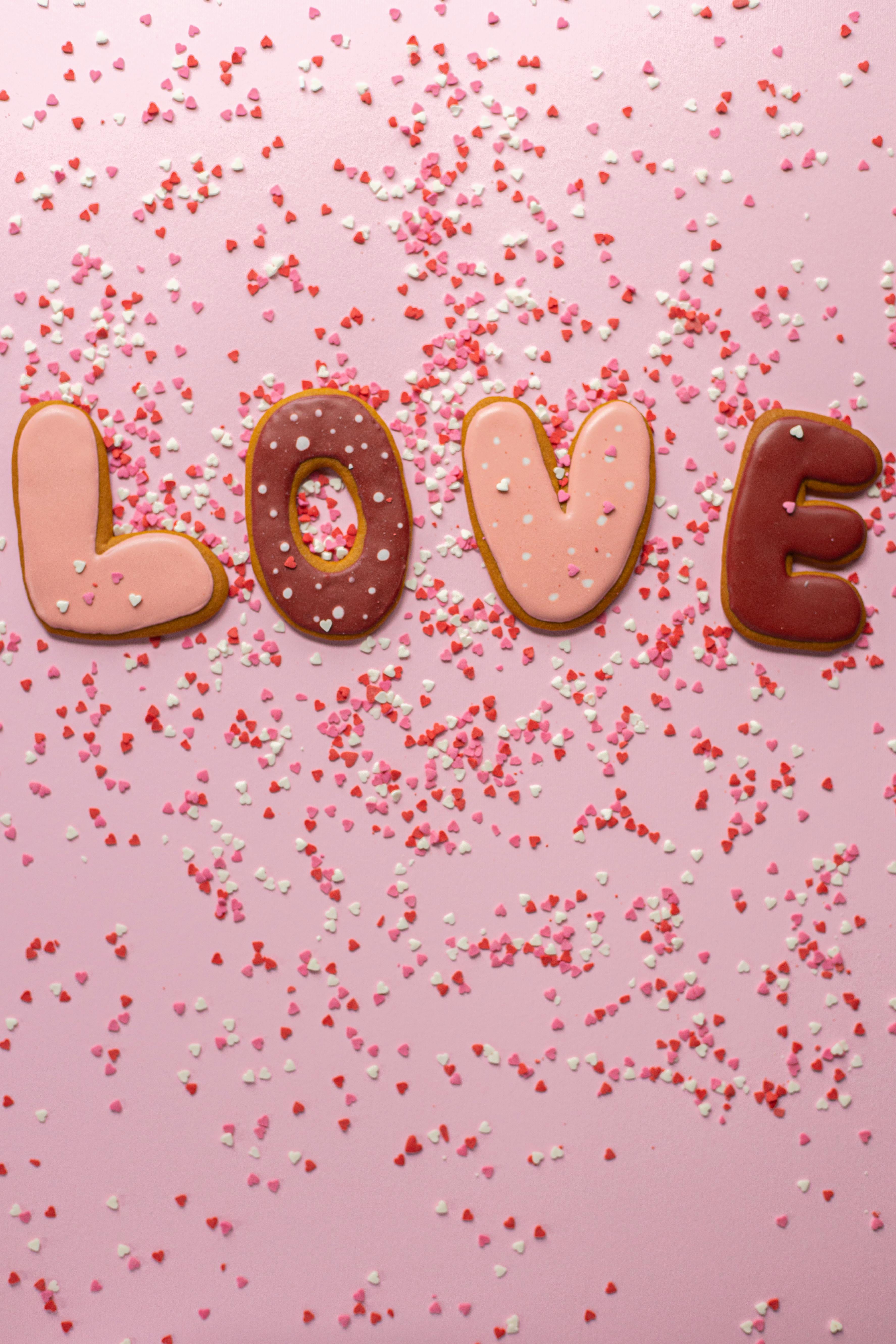 love word placed on pink surface