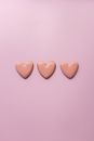 Small heart cookies on pink surface
