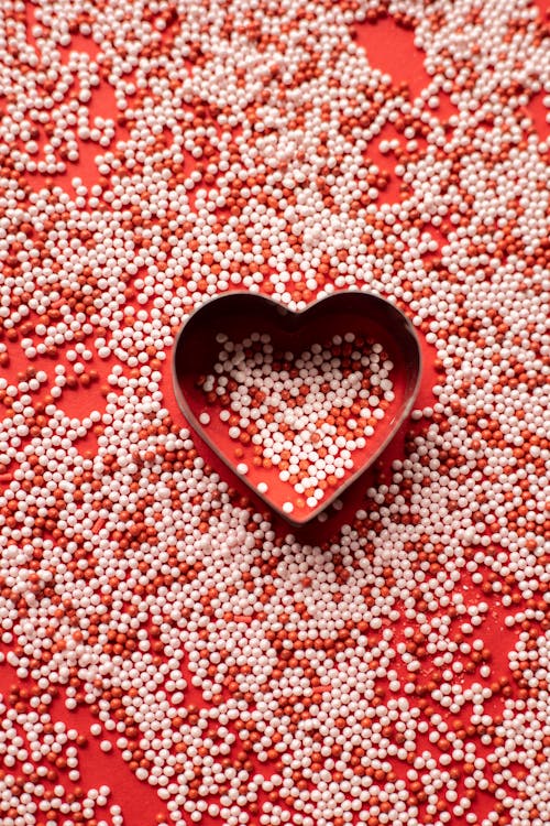 Free Heart near sprinkling on surface for Valentine day Stock Photo