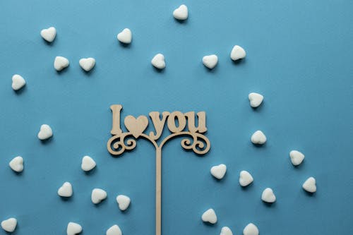 Free Scattered sprinkles and wooden decoration with inscription Stock Photo