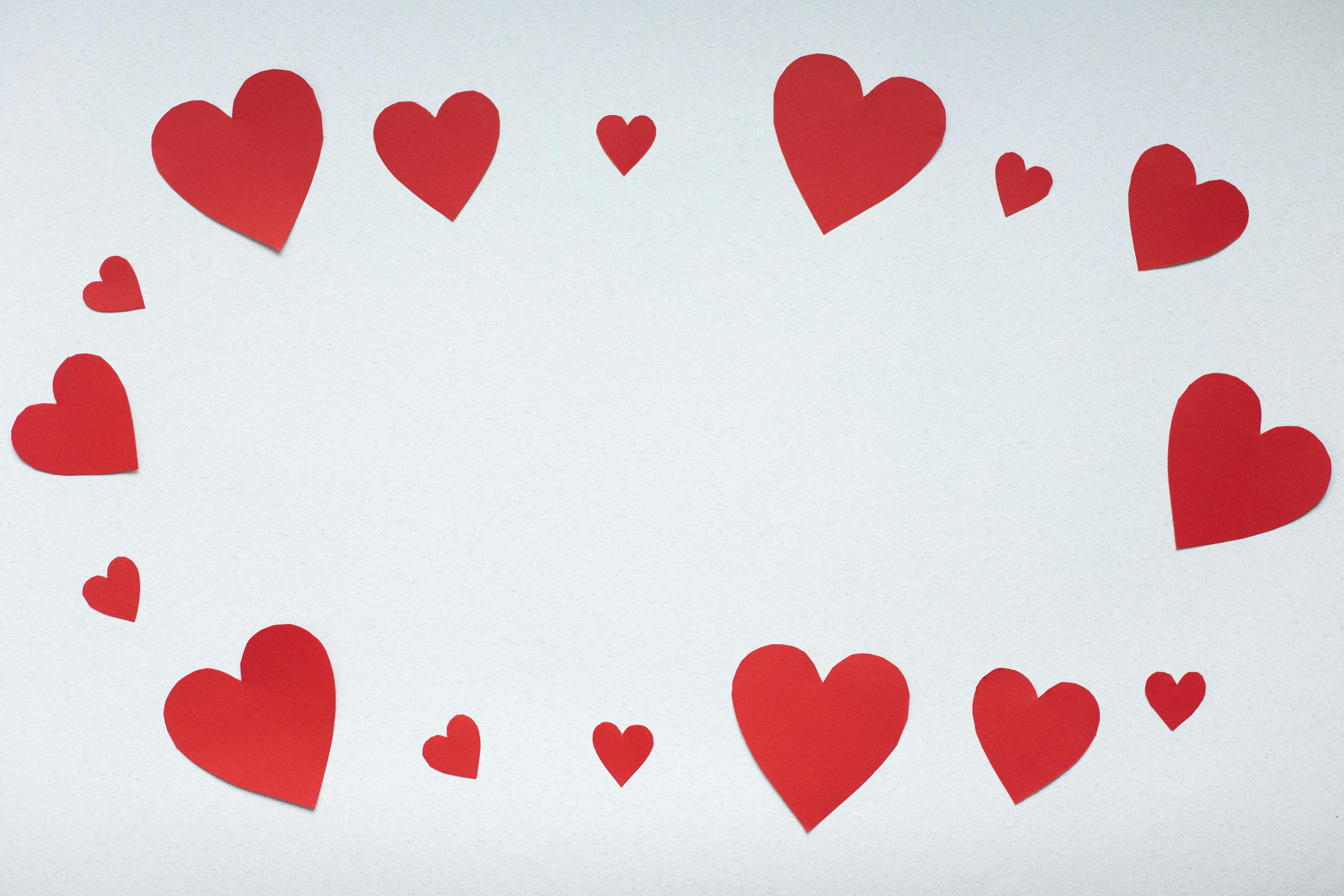 Hands cut out red paper hearts on a white background with scissors. View  from above. Valentine's day, mother's day, a symbol of love. Space for  copying. 11704165 Stock Photo at Vecteezy