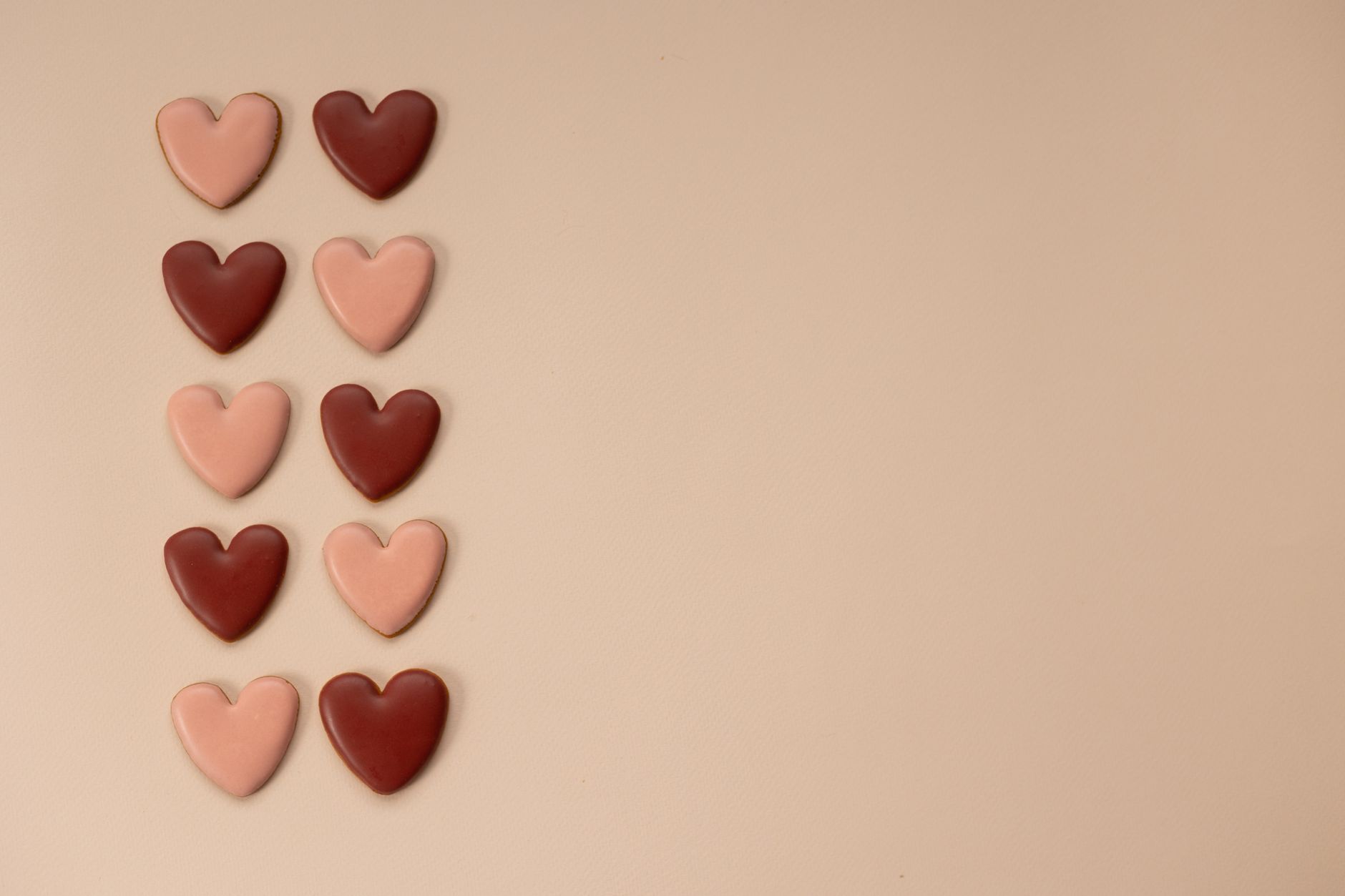 Hand breaking a ruby chocolate bar showcasing its rich pink color