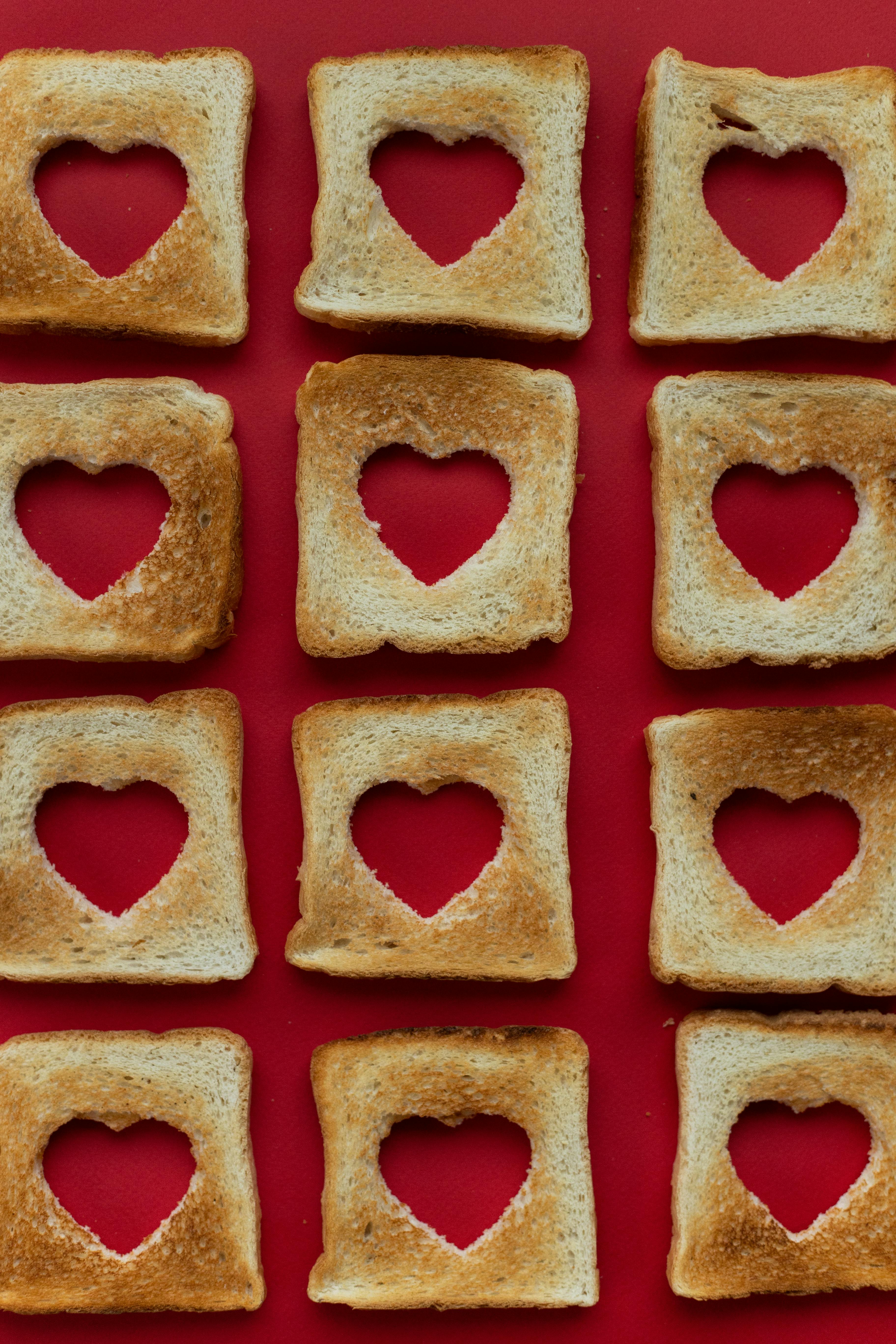 slices of toasted bread with cut out hearts in middle