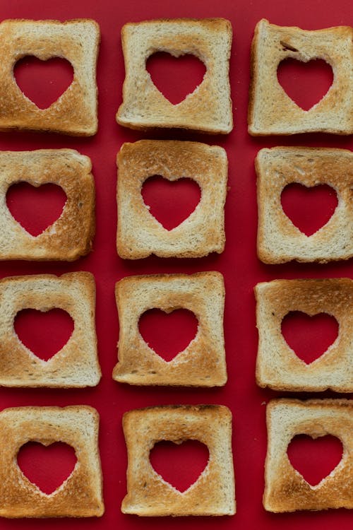 Slices of toasted bread with cut out hearts in middle