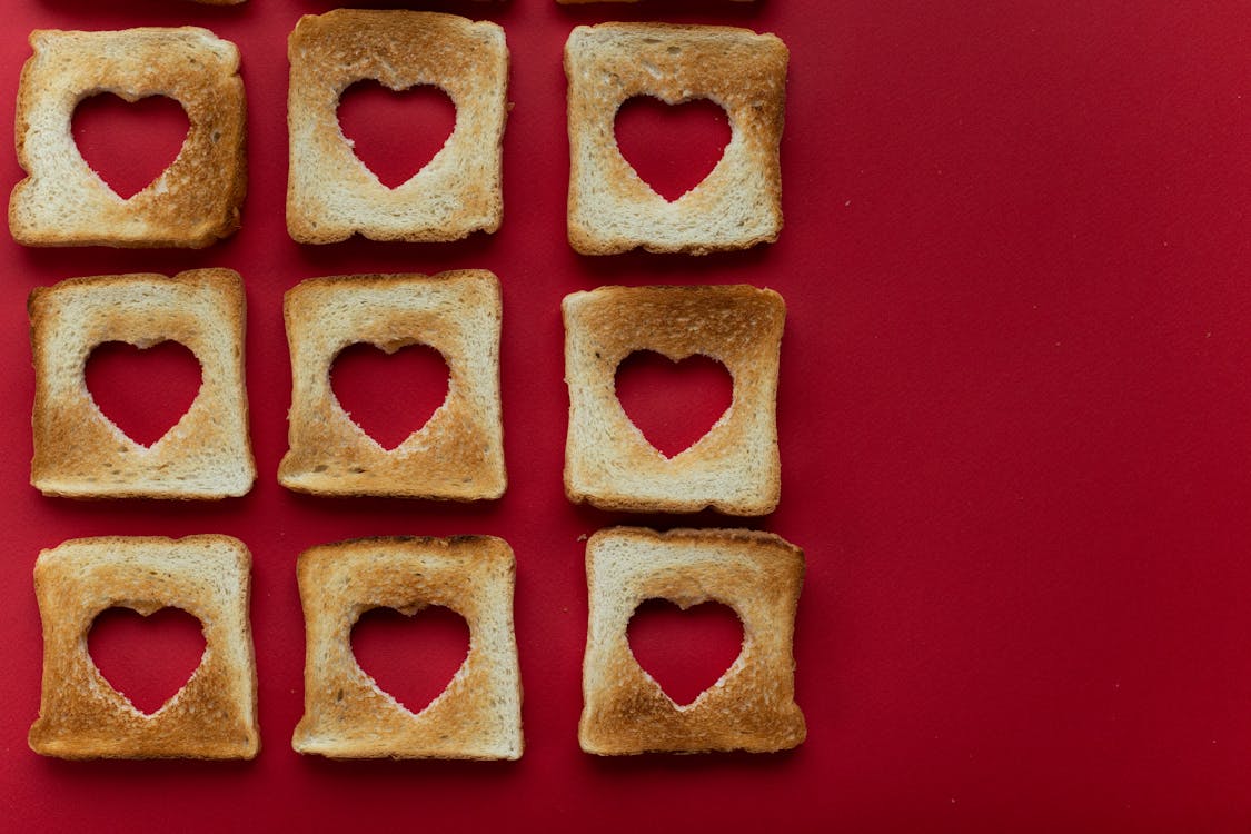 Composition of creative slices of toasted bread against red background