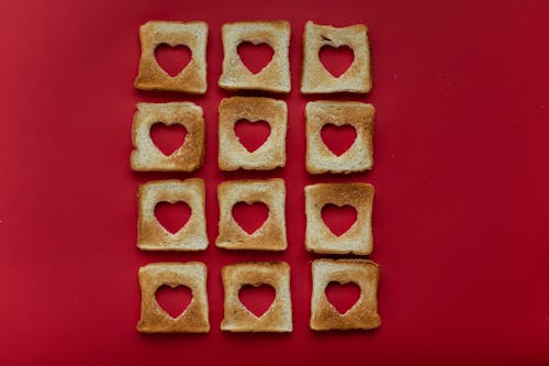 Free Creative slices of toasted bread placed on red background Stock Photo