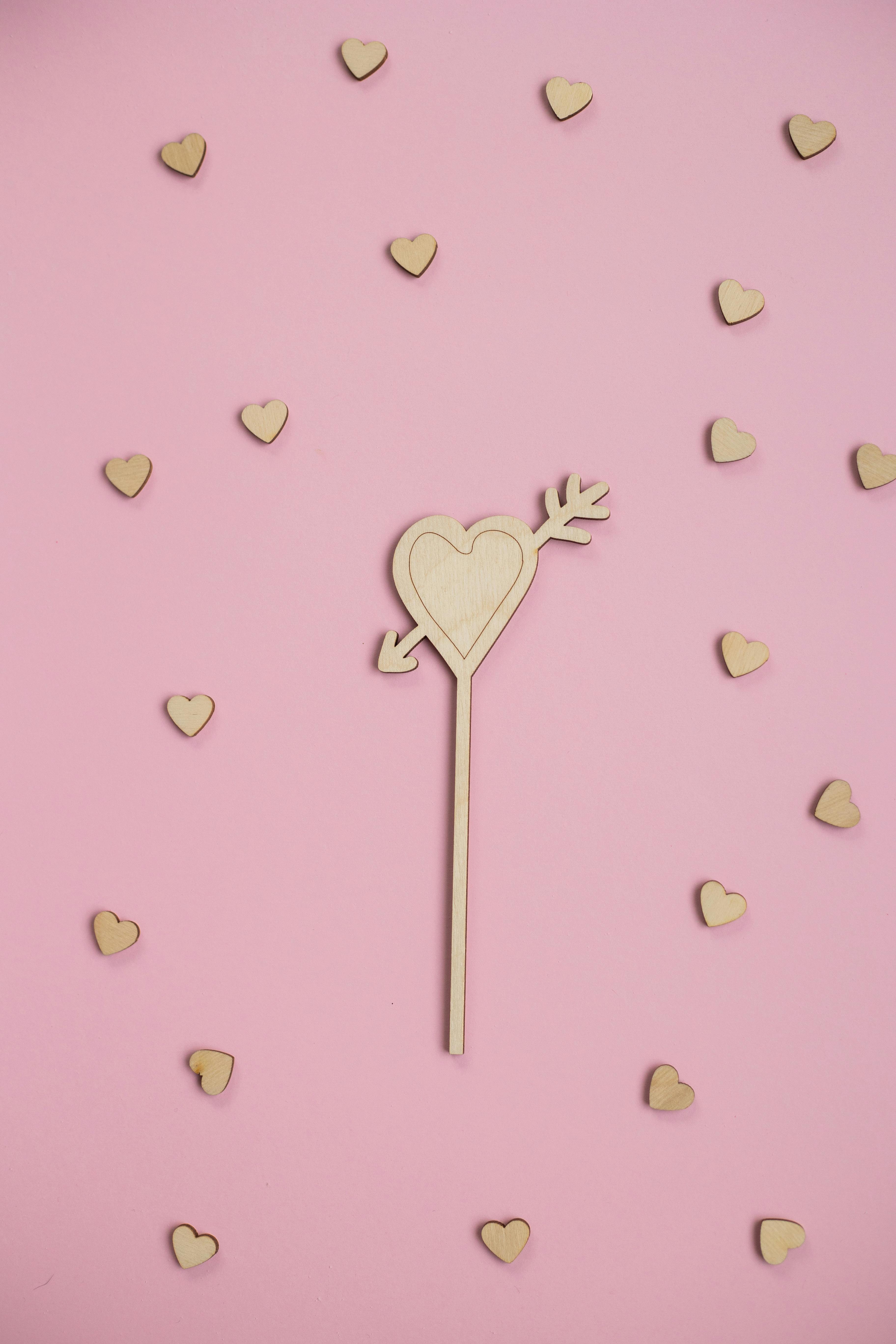 Creative Wooden Hearts Against Pink Background · Free Stock Photo