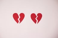 Broken paper hearts on white background