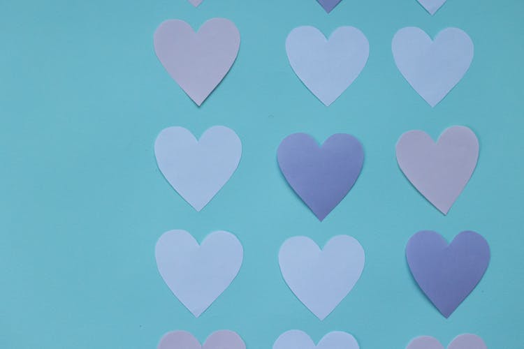 Cutout Paper Hearts On Blue Background