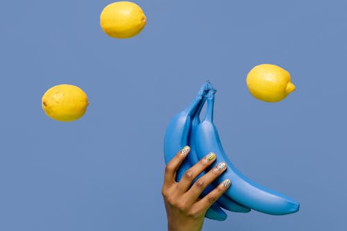 Close-Up Shot of a Person Holding Blue Bananas