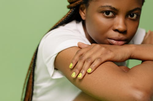 Close-Up Shot of a Woman in White Top Sitting