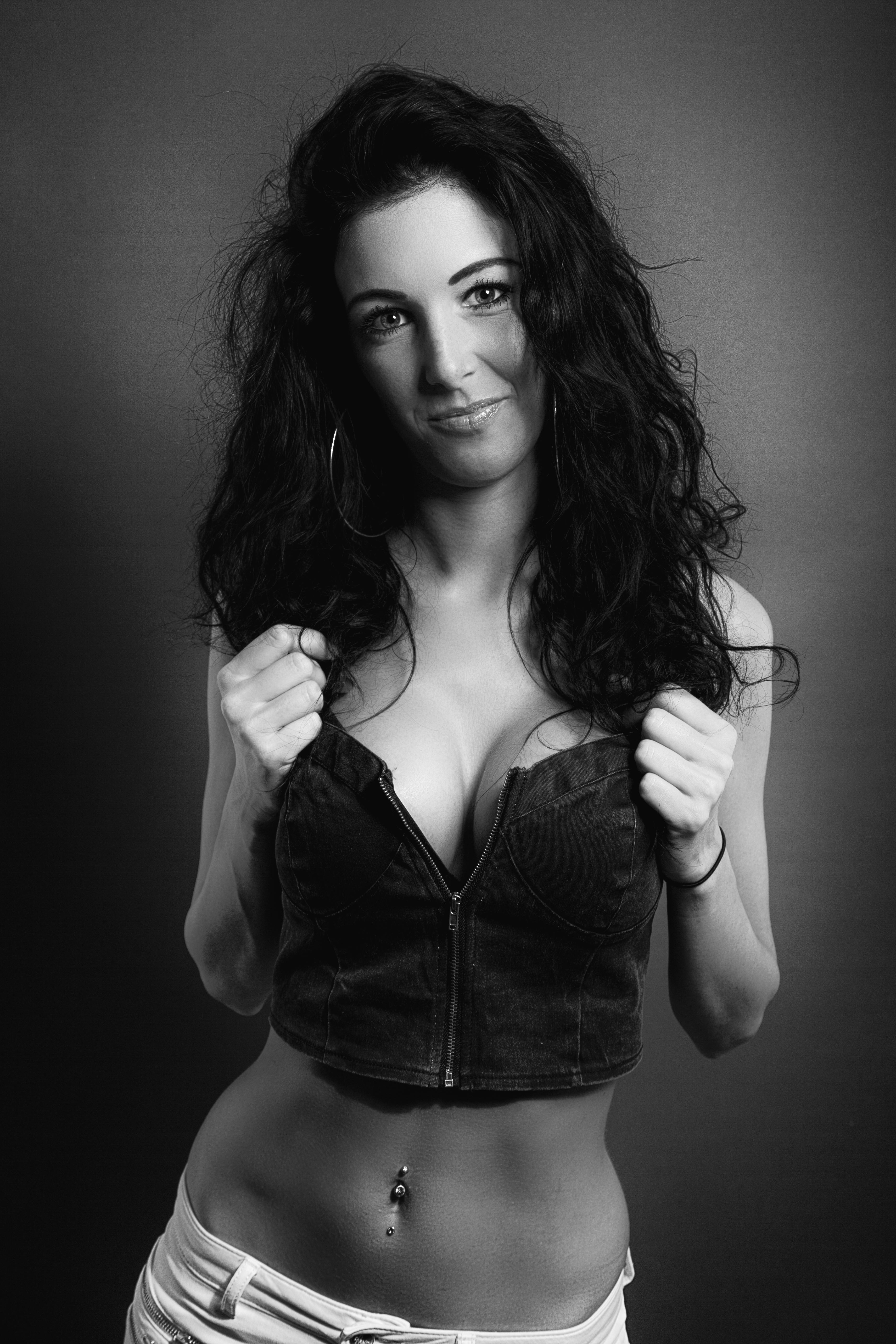 Monochrome portrait of a woman in a tube top with hoop earrings, Leipzig.