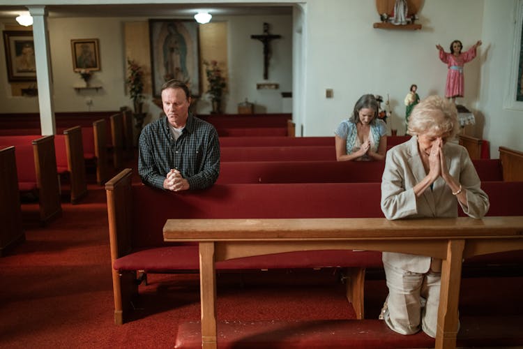 Elderly People Praying Inside The Church