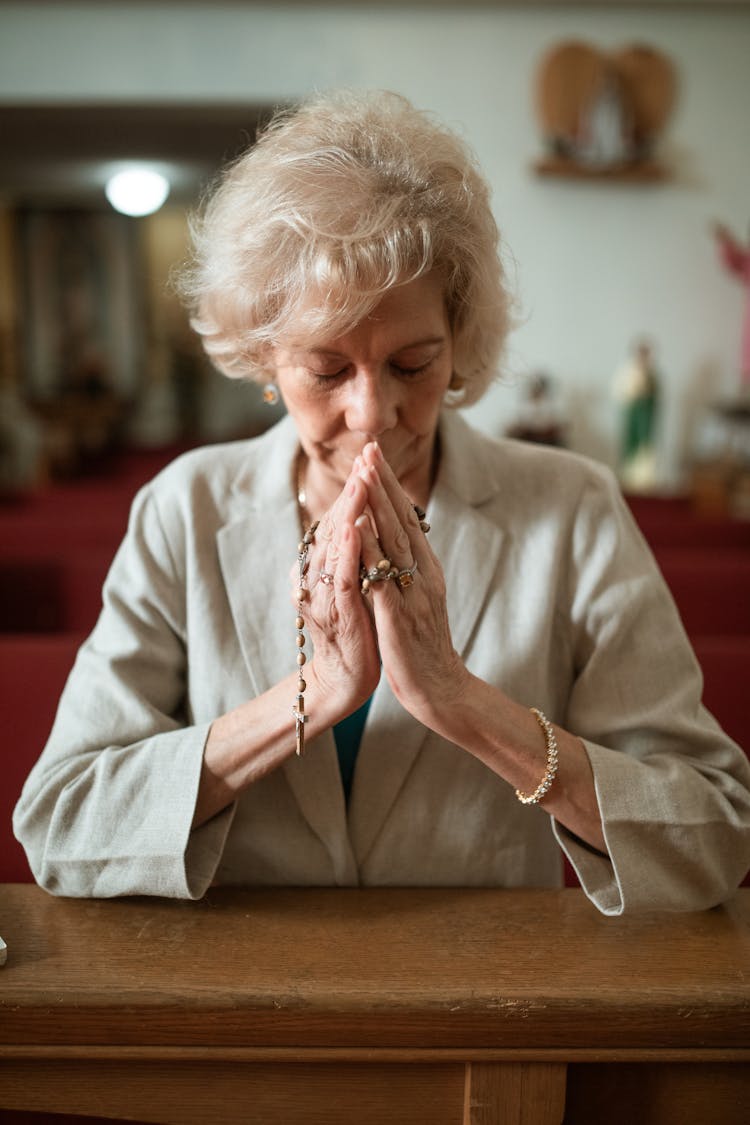 Close-Up Shot Of An Elderly Woman Praying In The Church