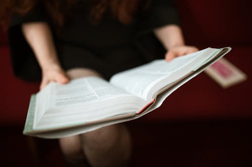 Close-Up Shot of a Person Reading a Bible