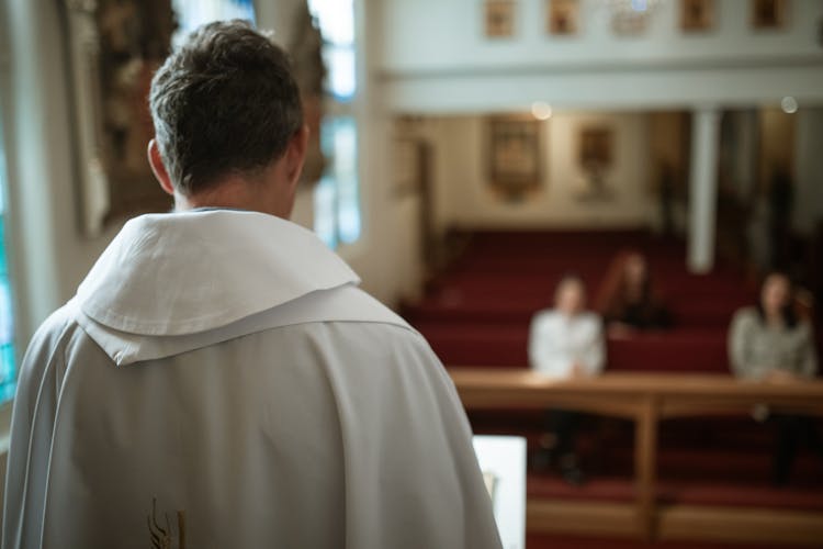 People Sitting On The Church Pews