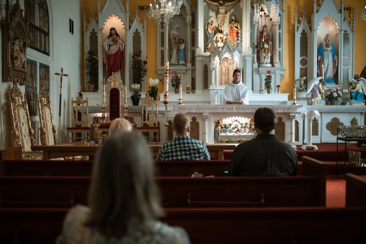 People Sitting On The Church Pews