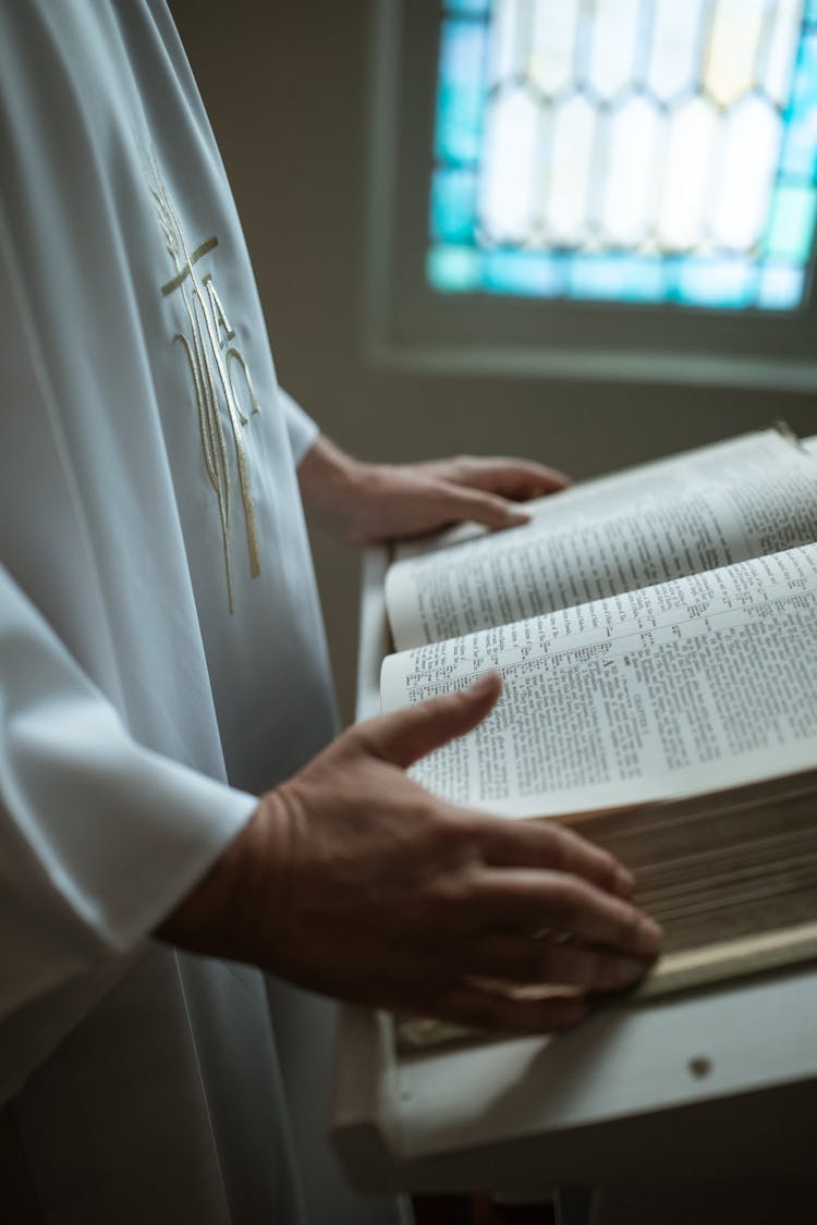 A Priest Holding A Bible