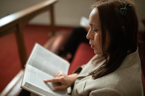 Free Close-Up Shot of a Woman Reading a Bible Stock Photo