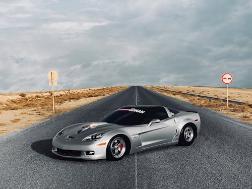 Free A Silver Sports Car on the Road Stock Photo