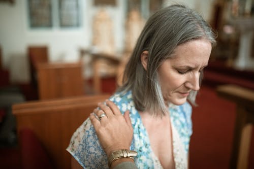Close-Up Shot of a Woman Praying