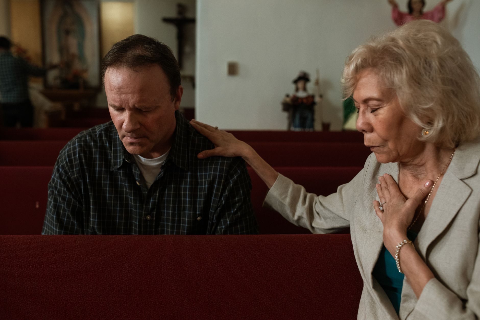 Healing and faith shown through prayer and support in a church pew
