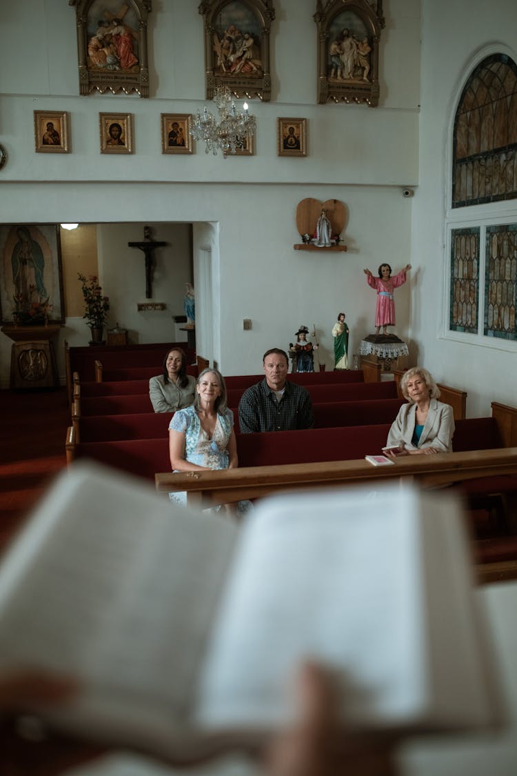 People Sitting On The Church Pews