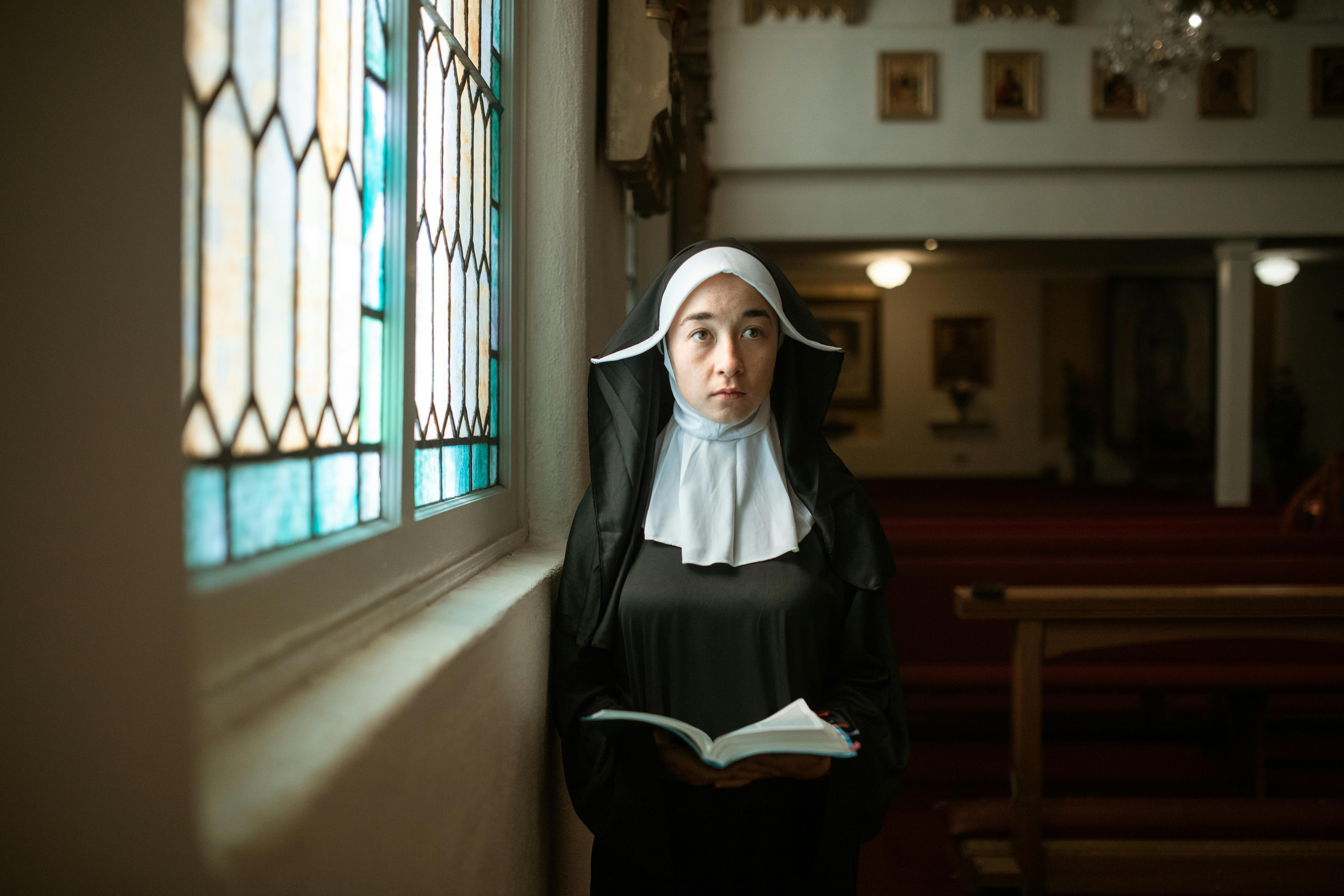 a nun holding a bible